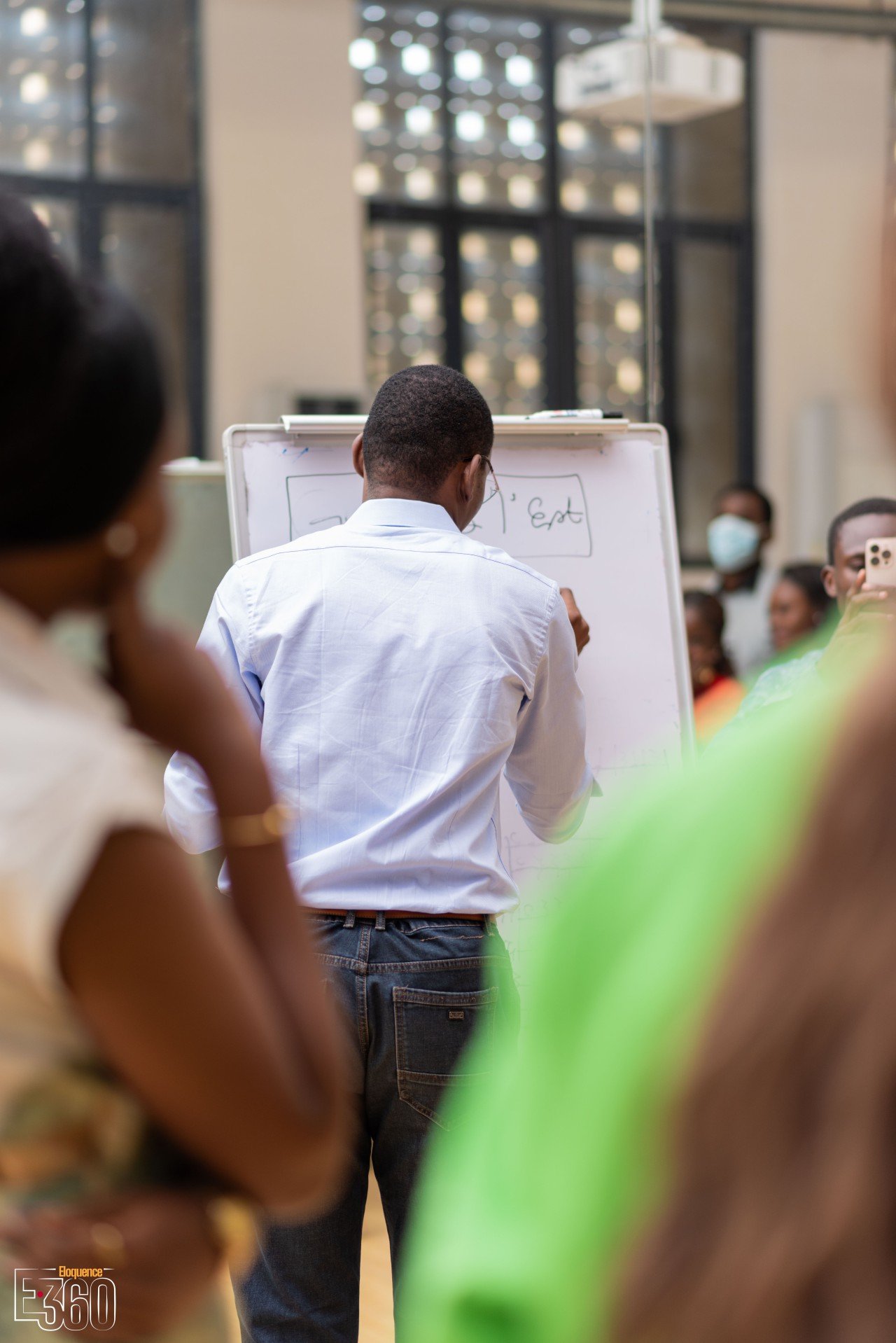 Un intervenant travaille au tableau devant les participants d’un atelier.